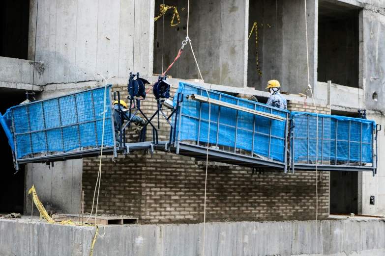 a couple of men are repairing an up bridge