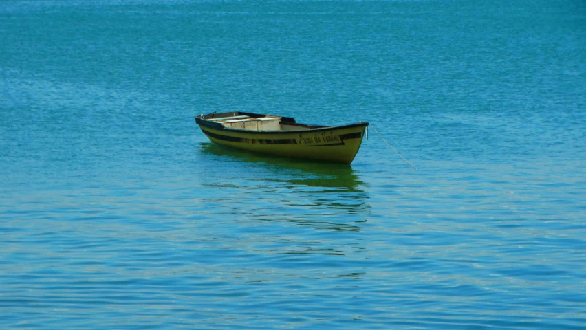 a small boat out in the blue water