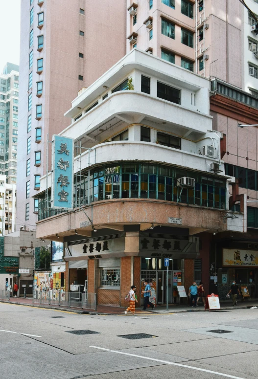 some people standing around in front of a tall building