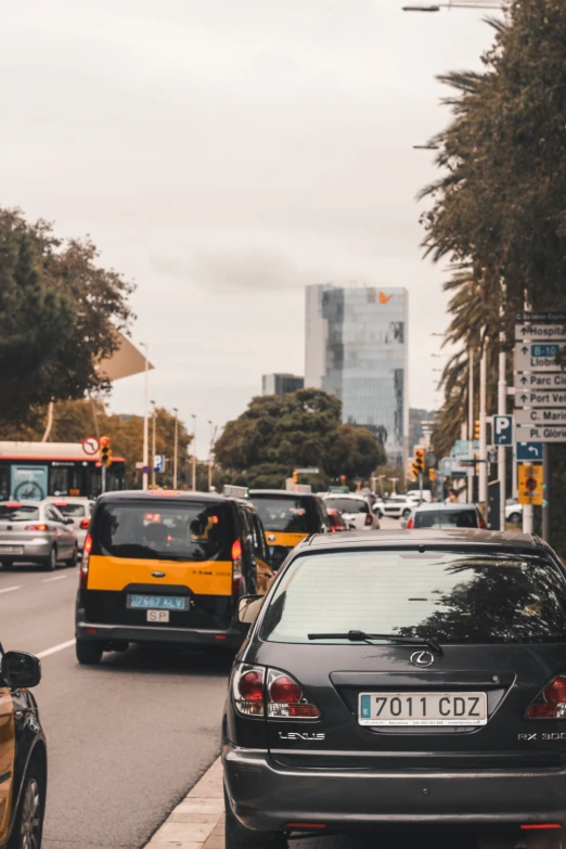 a busy street is packed with cars and buses