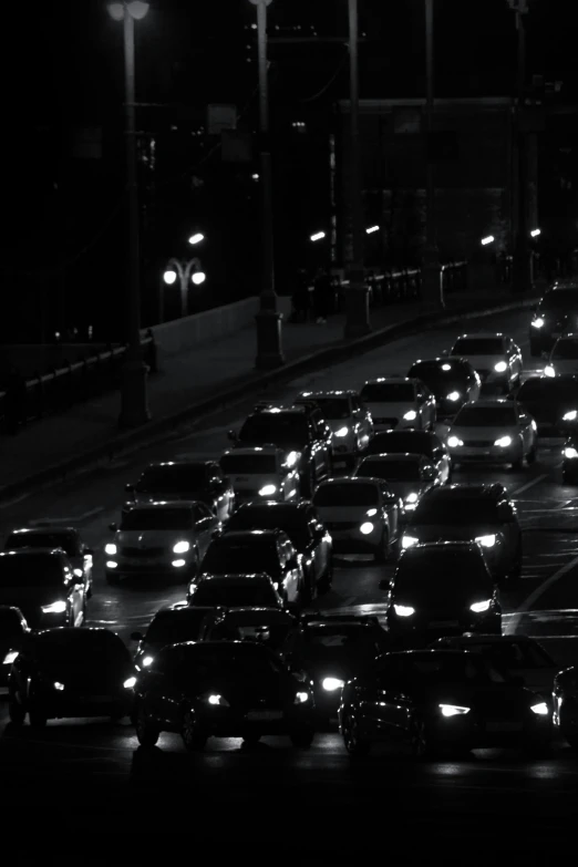 many cars line up on the road in a dark city