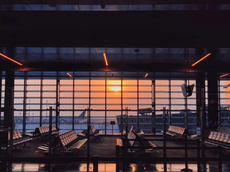 the sun is shining brightly through an airport terminal