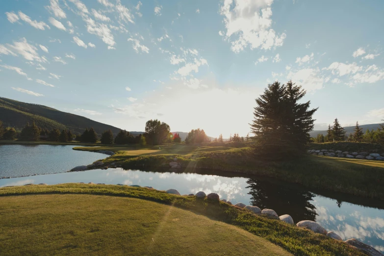 a po of a golf course at sunset