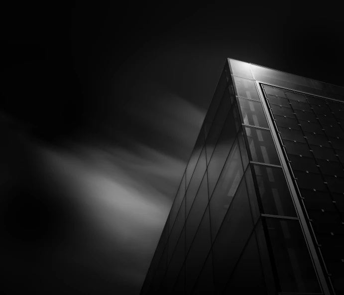 dark tall building against grey sky on a cloudy day