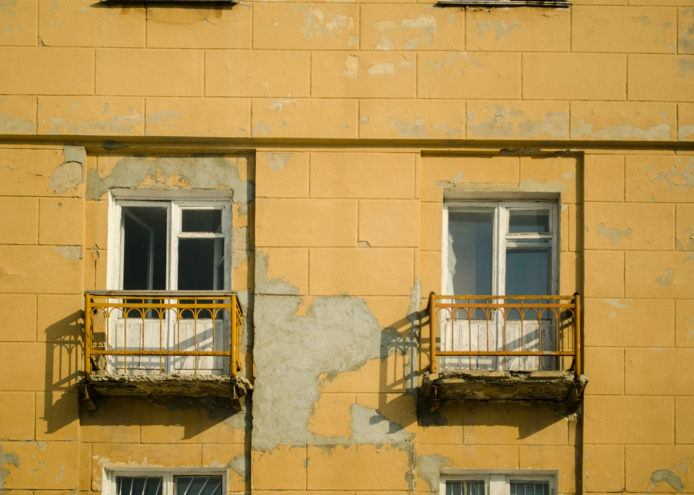 two large windows in an empty apartment building