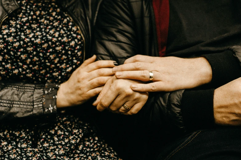 two people holding hands in the middle of a po