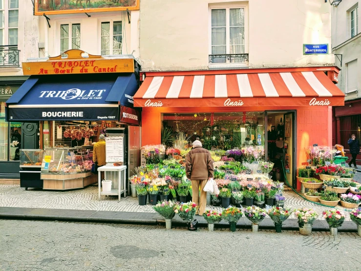 flowers on the outside of a storefront