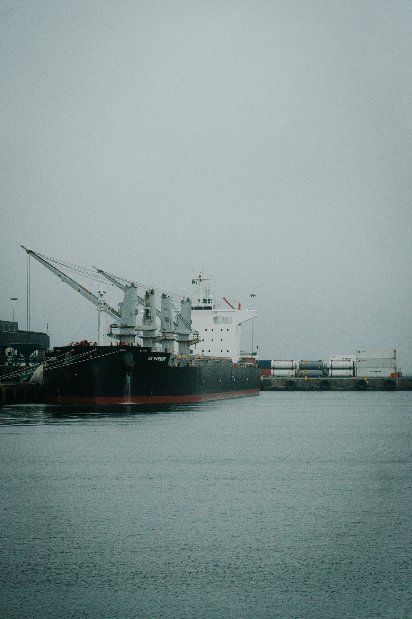 the large ship is docked on the harbor