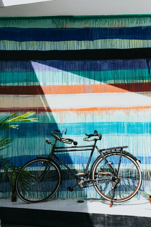 a bike is shown against a multi colored wall