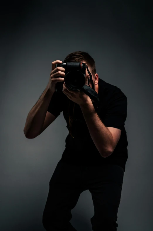 a man takes a picture in a dark spot