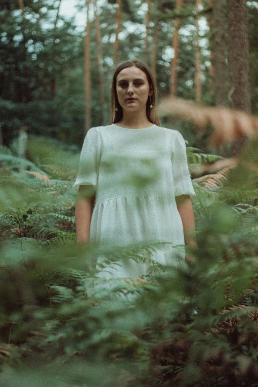 woman wearing white in forest setting during daytime