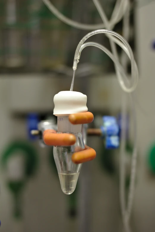 a tube that has a light turned on with orange and white sticks coming out of it