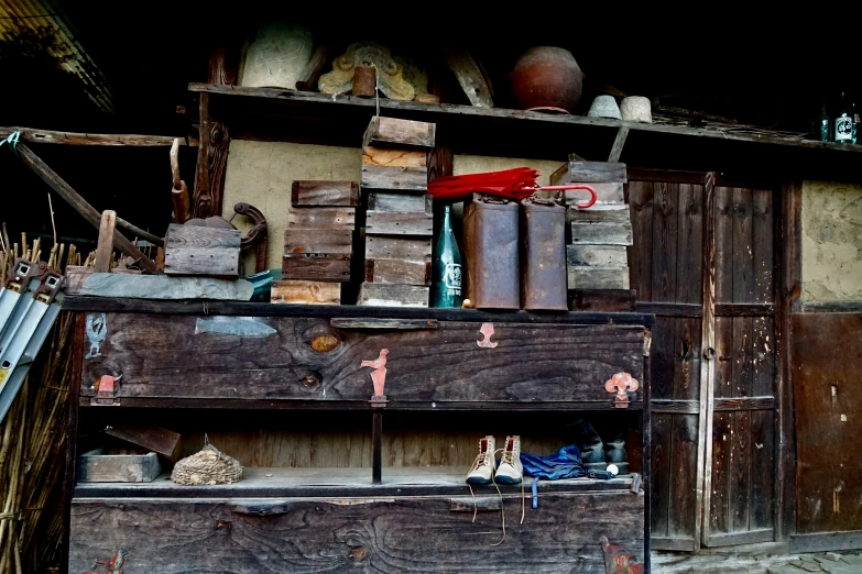 a wooden cabinet has many items on it