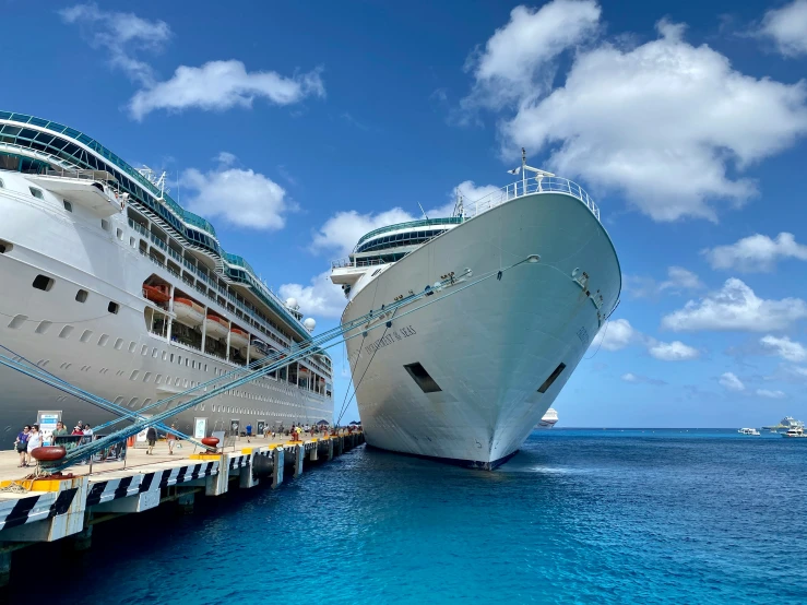 two cruise ships next to each other on a bright sunny day