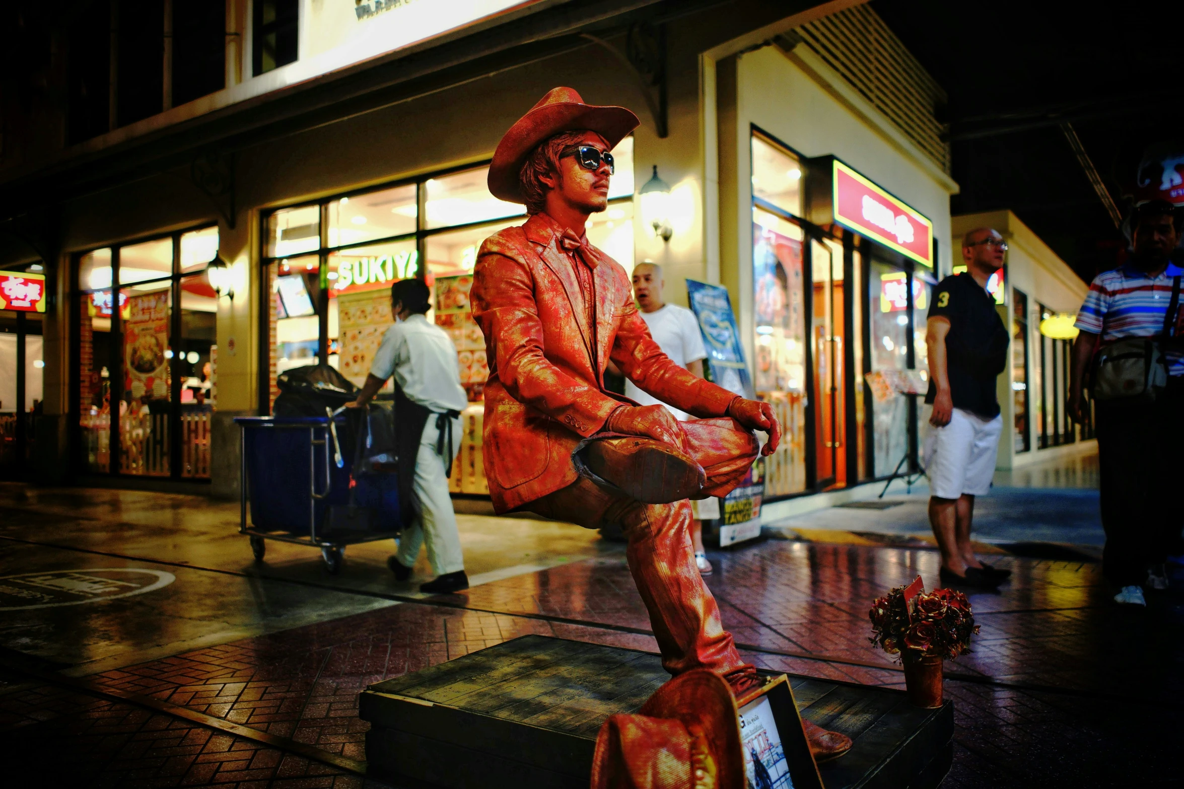 a life - sized statue of a person wearing a hat and clothes