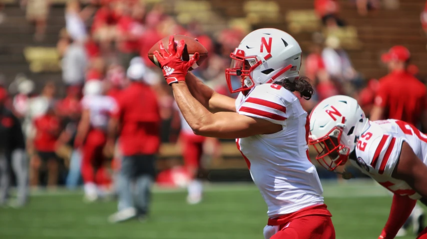 two football players one wearing white and red