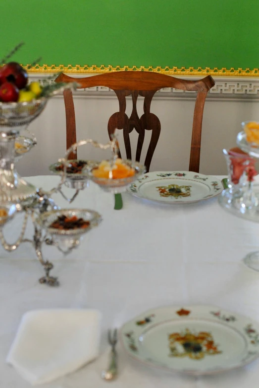 a table with plates and cups with candles