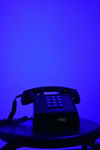 an old cellphone on a stool with blue lighting