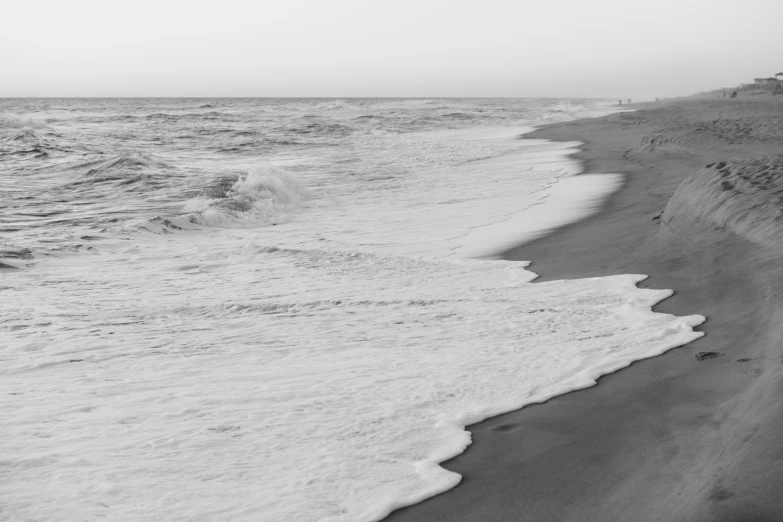 a person walks along a beach next to an ocean