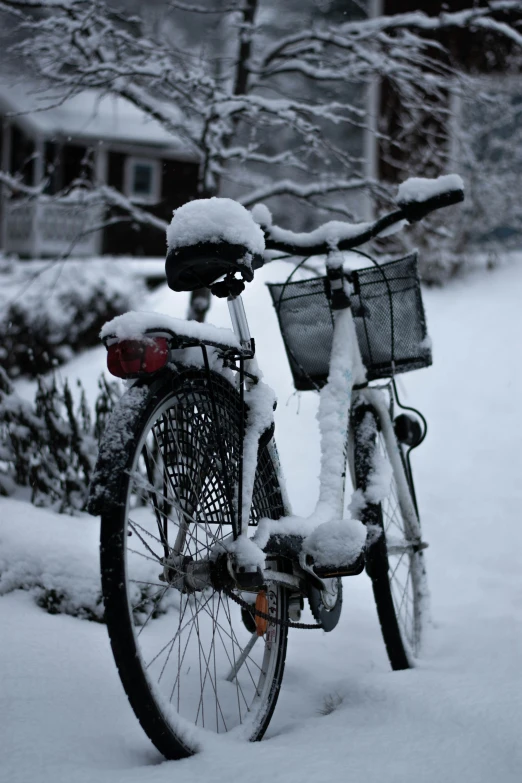 an old bicycle has been completely covered with snow