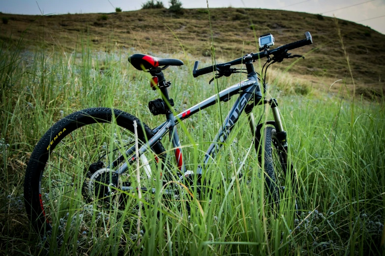 a bike in a field with its gears resting on it