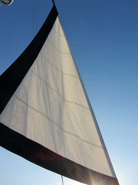 there is a large white sail on a boat