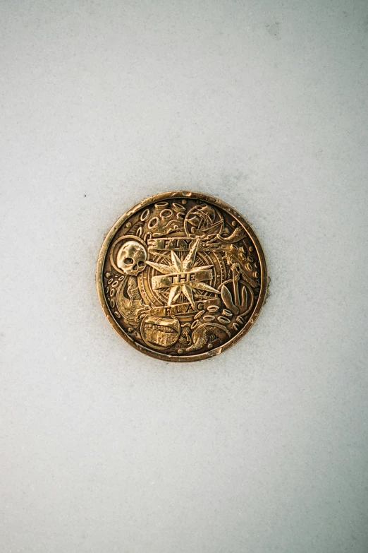 a gold coin sitting on top of a table