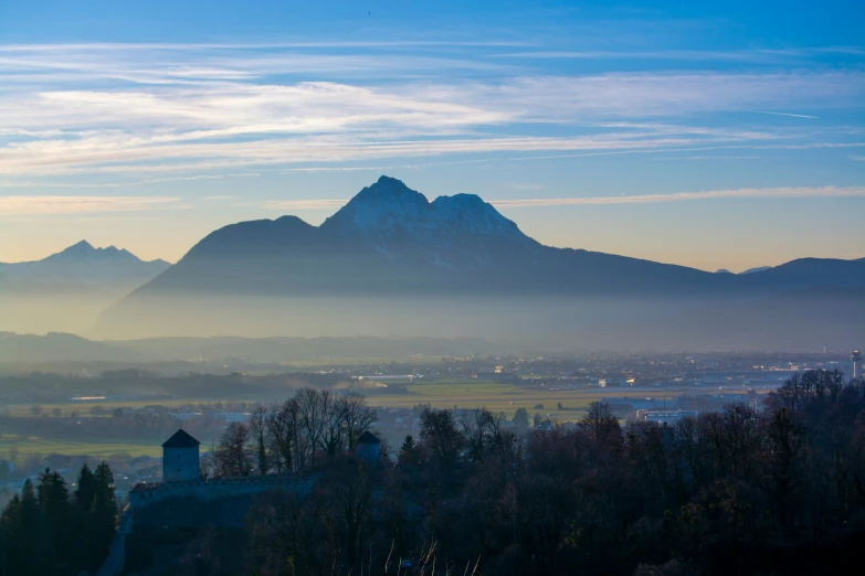 a town surrounded by mountains in the distance