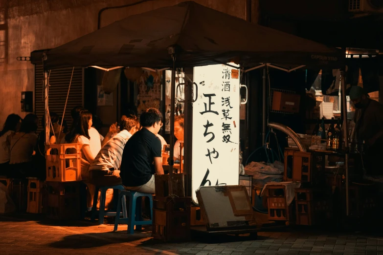 a group of people standing around a restaurant with asian writing