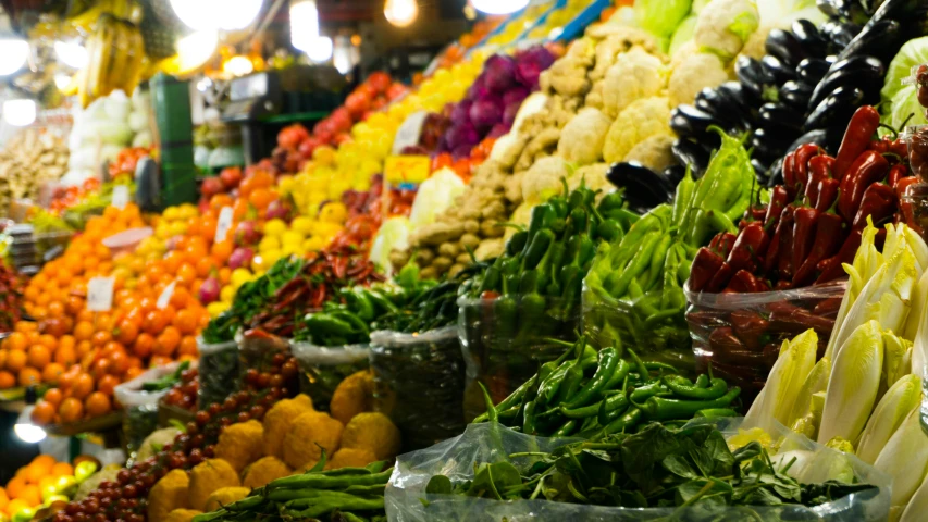 fruit and vegetables are in large groups at a store