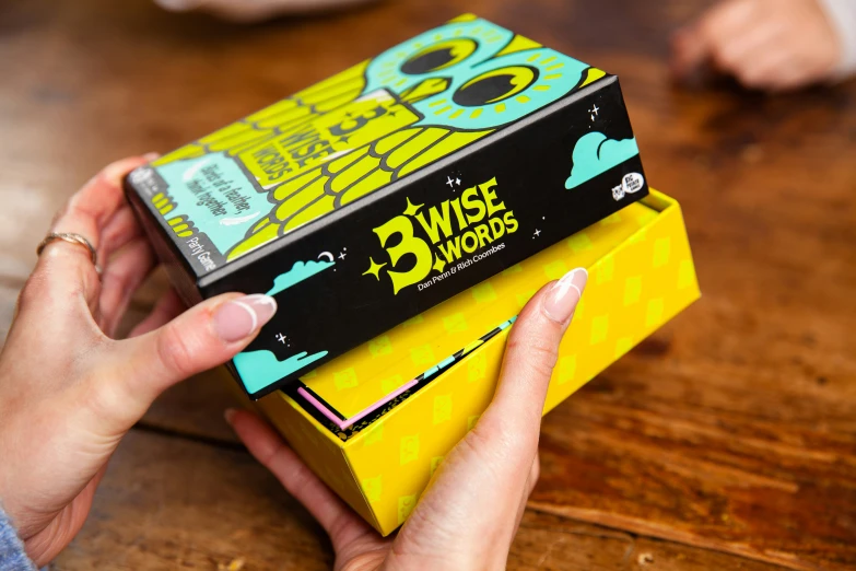 a person holds a yellow box for three decades