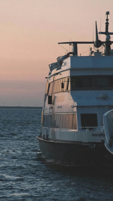 a large white boat on the water with a sky background