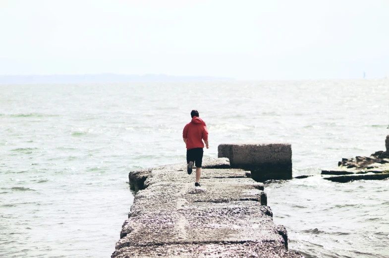 a man standing on a pier over water