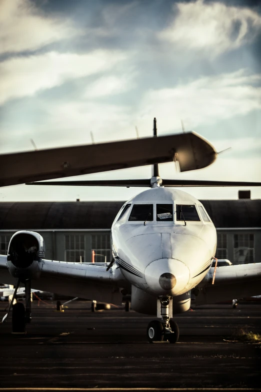 a small propeller airplane parked on a run way