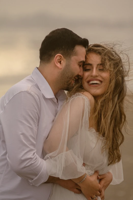 a man and woman are cuddling close together in the sunset