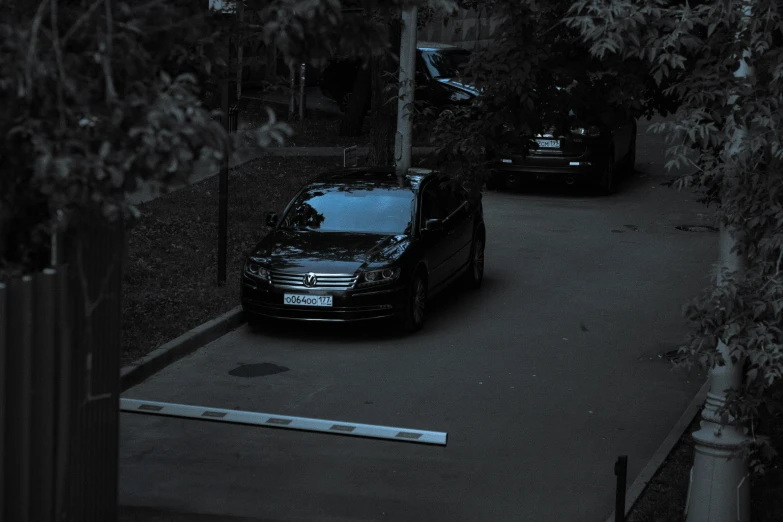 a small black car traveling down the road in the dark