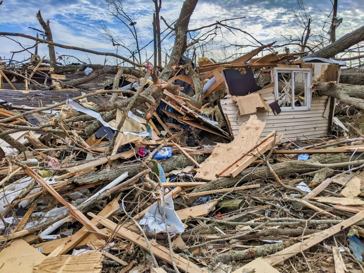 an old house with debris piled on top