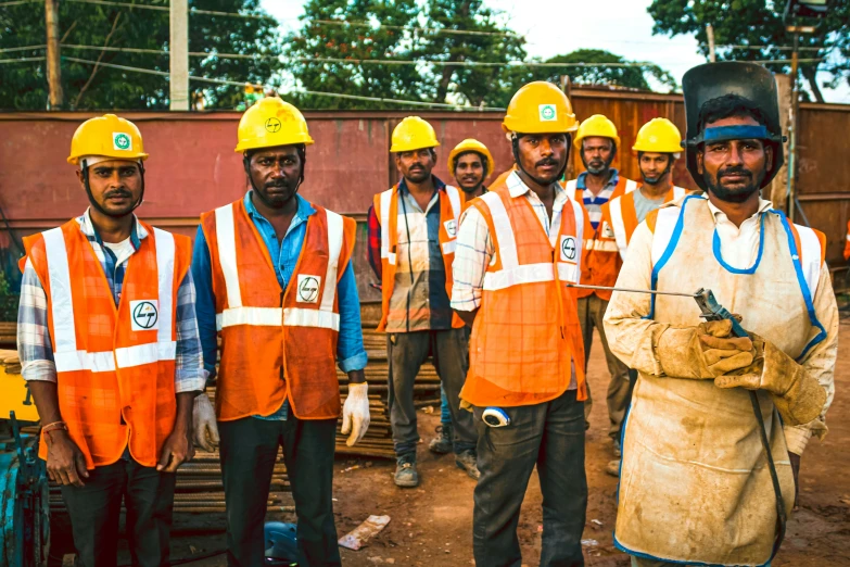 some men in hard hats and safety jackets