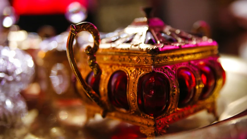 a fancy jeweled box sitting on a silver platter