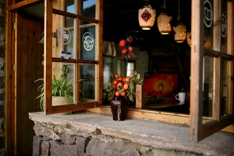 a vase with flowers sits on the window sill