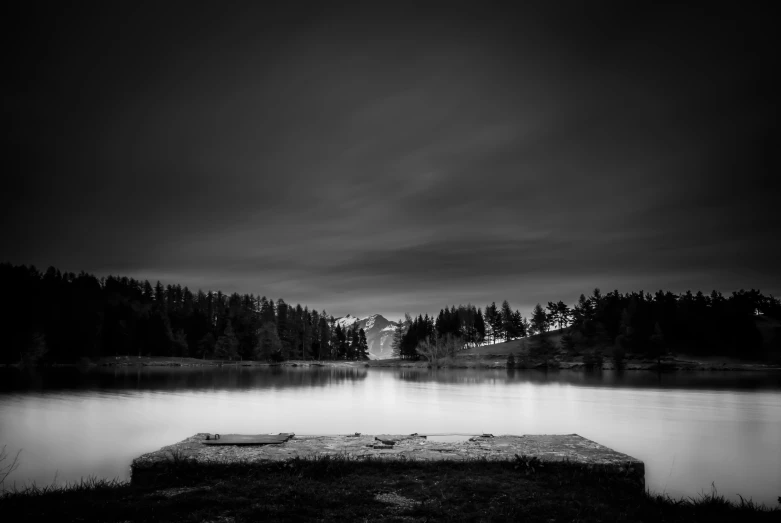 a pier sits out in a lake at night