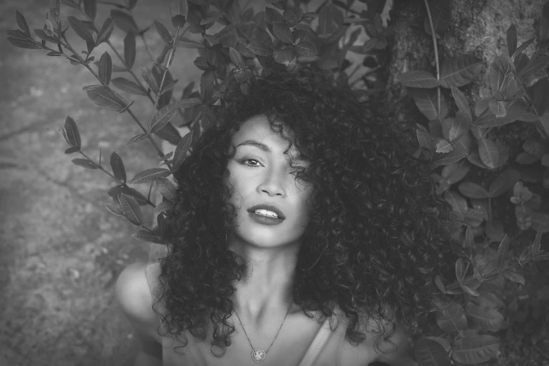 a close up s of a woman with her curly hair tied back