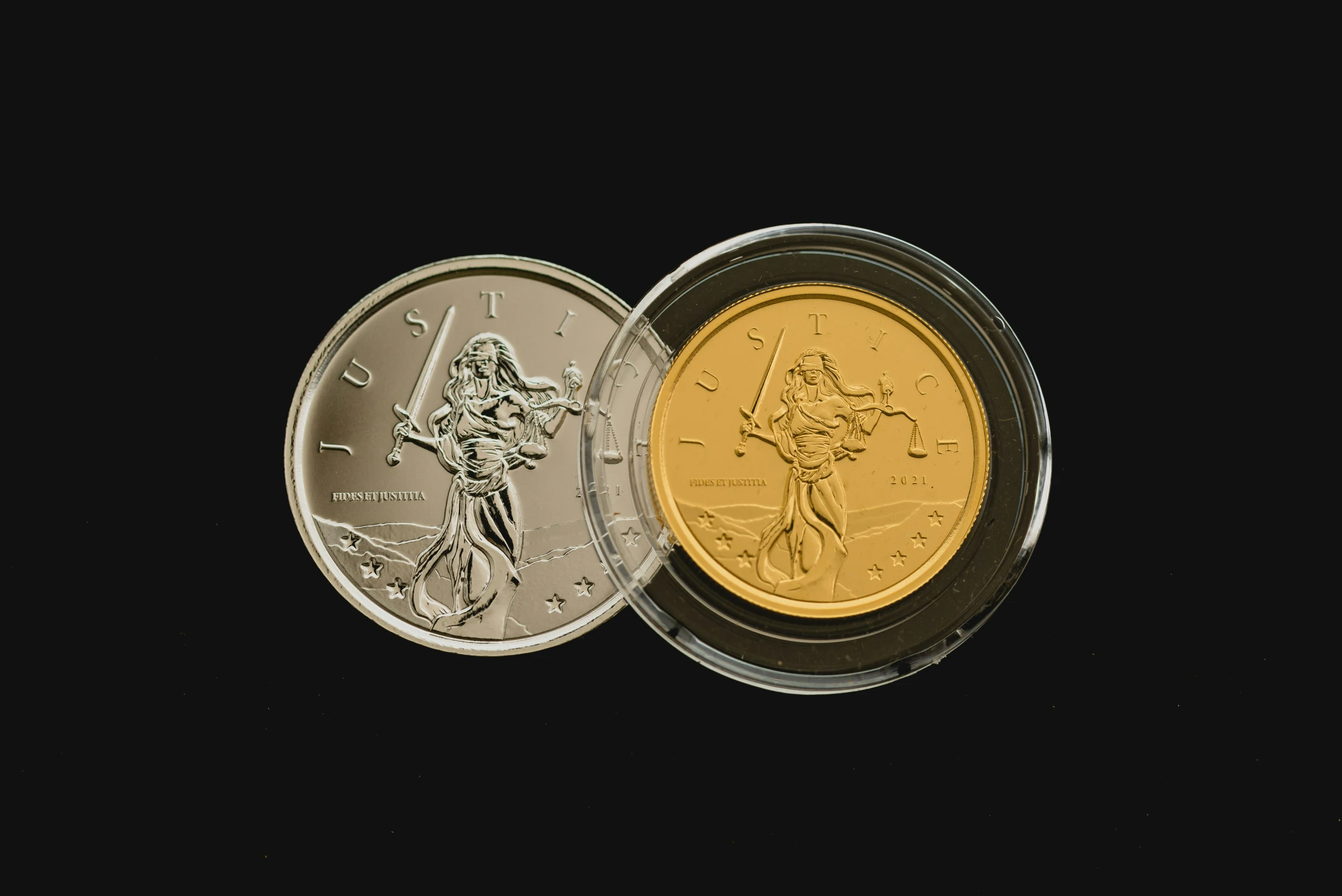 two coin with a person holding a sword