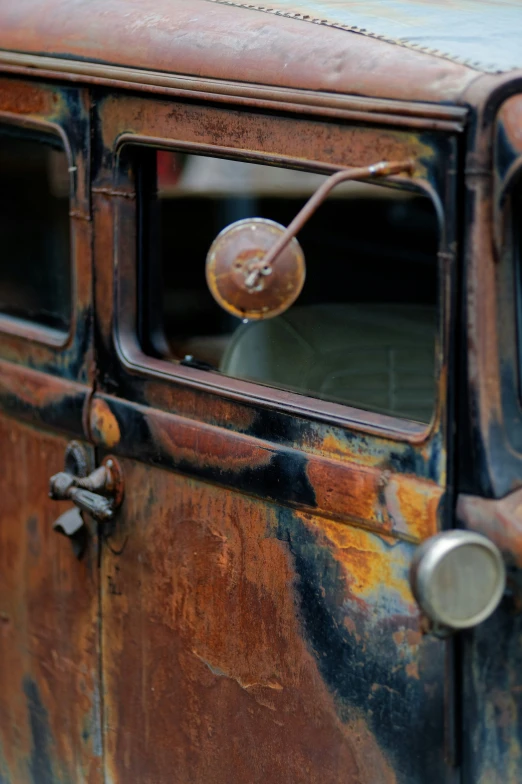 old rusted car with wooden dashing and rust on the window