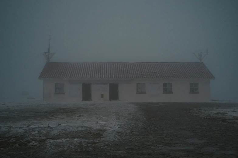 a home in the fog with no roof and windows