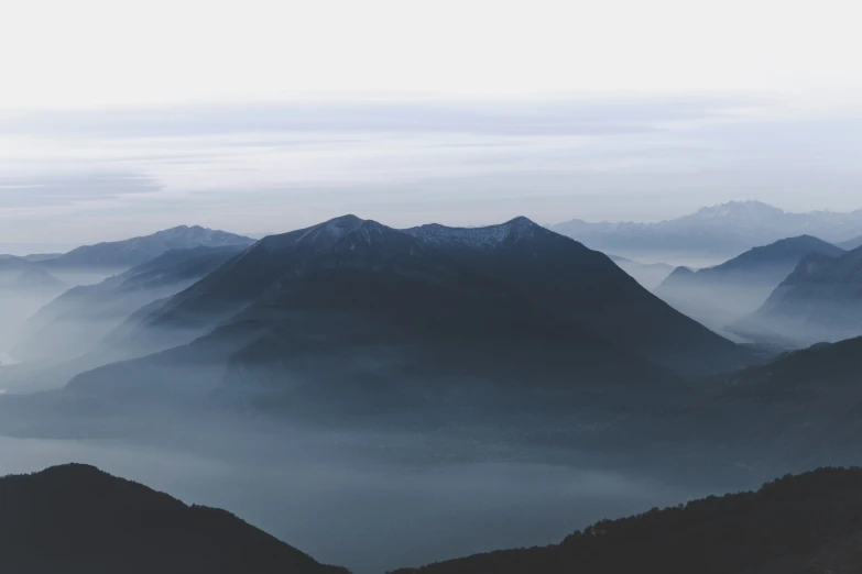 a bunch of mountains are seen in this black and white po