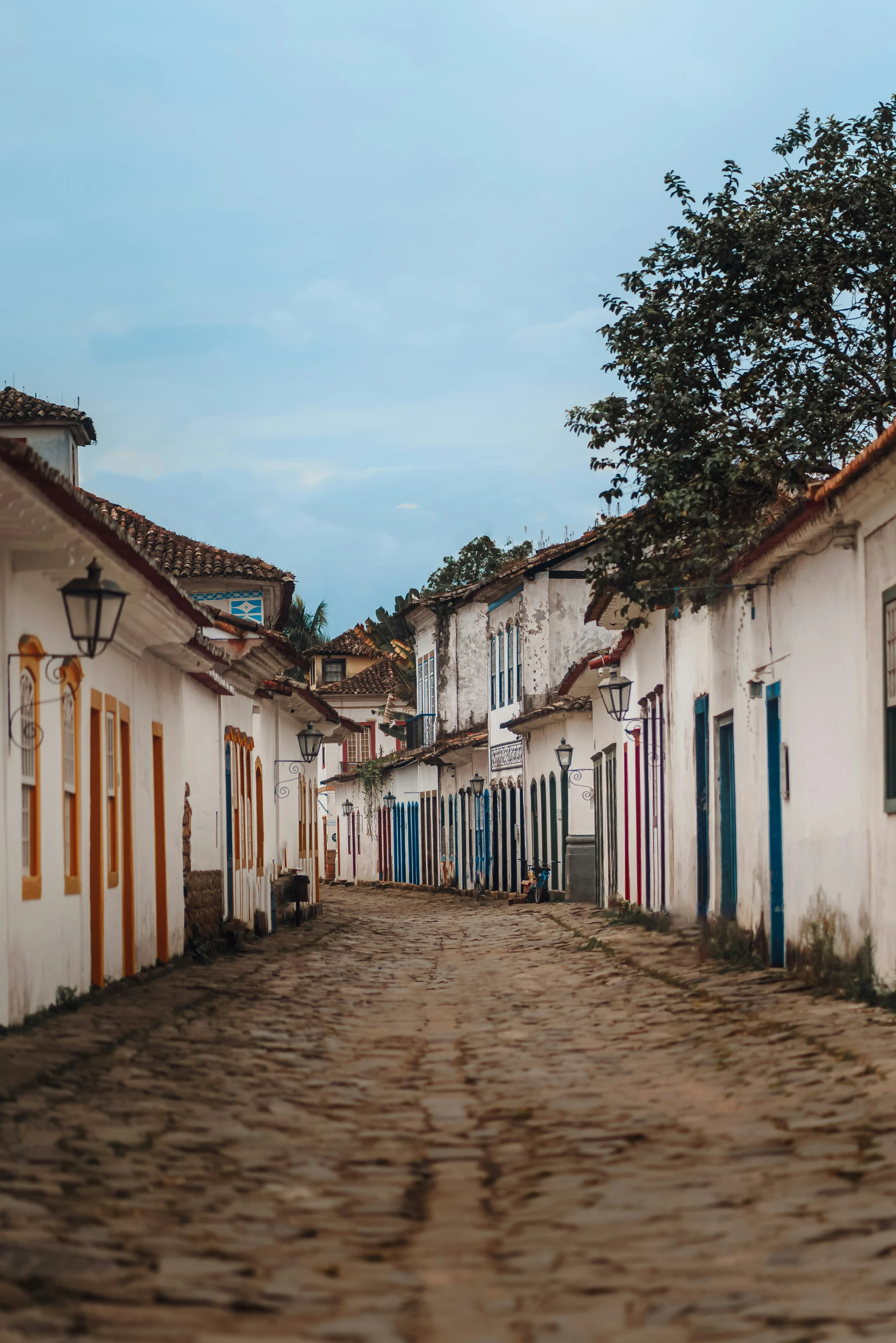 a narrow street with some buildings on the side