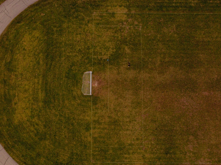 an aerial s of a soccer field with the ball going into the goal