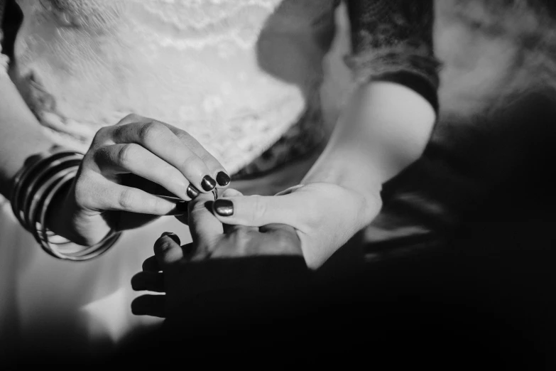 two people holding hands with nail polish on each hand