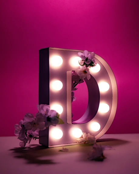 a letter that has been decorated with lights and flowers